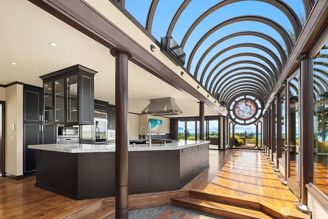 a very nice looking living room with a large window and chandelier