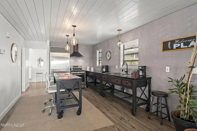 a view of a livingroom with wooden floor and a chandelier