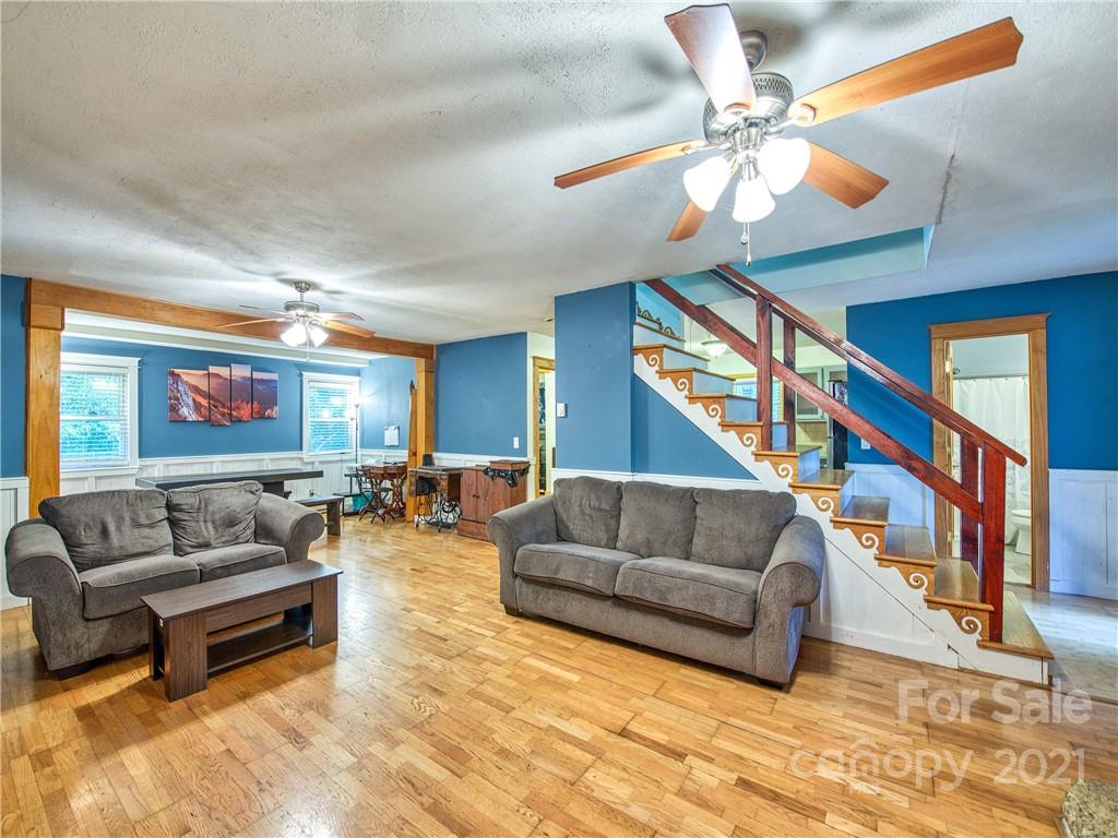 885 Rustic Heights Road Waynesville, NC 28785 - Photo 8 of 32 a living room with furniture and a ceiling fan