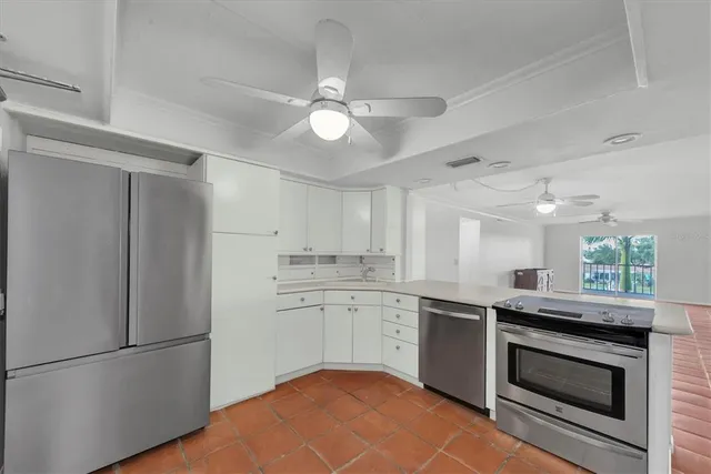 a kitchen with a sink stainless steel appliances and cabinets