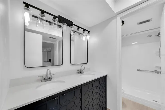 a bathroom with a double vanity sink mirror and double