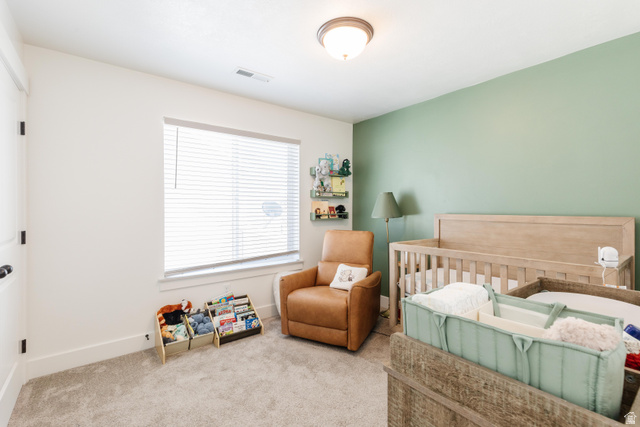 349 West 3085 South Logan, UT 84321 - Photo 21 of 37 Bright room with light green accent wall, neutral carpet, and a window featuring horizontal blinds