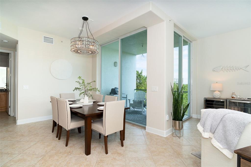 1375 Beach Road, Unit 210 Englewood, FL 34223 - Photo 11 of 49 a dining room with furniture a chandelier and window