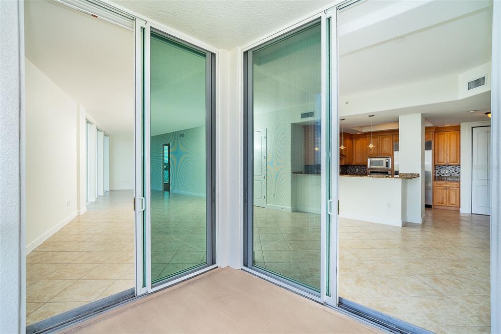 1375 Beach Road, Unit 210 Englewood, FL 34223 - Photo 12 of 49 a view of a hallway with wooden floor and a living room