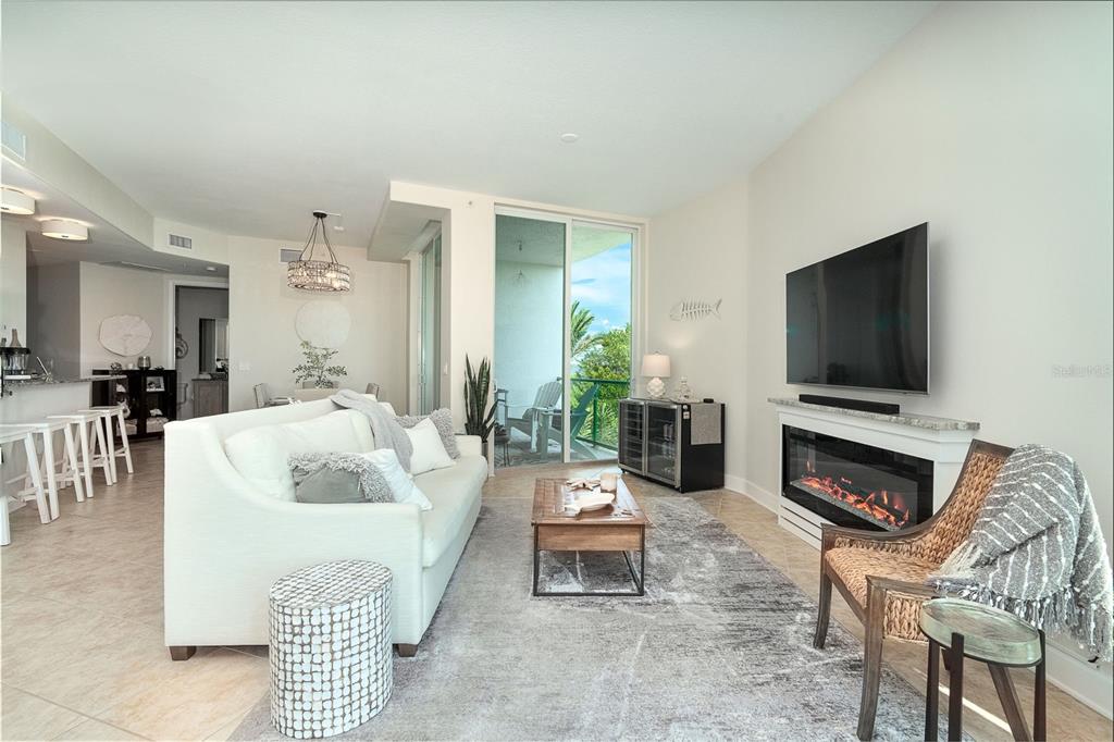 1375 Beach Road, Unit 210 Englewood, FL 34223 - Photo 18 of 49 a living room with furniture a flat screen tv and a fireplace