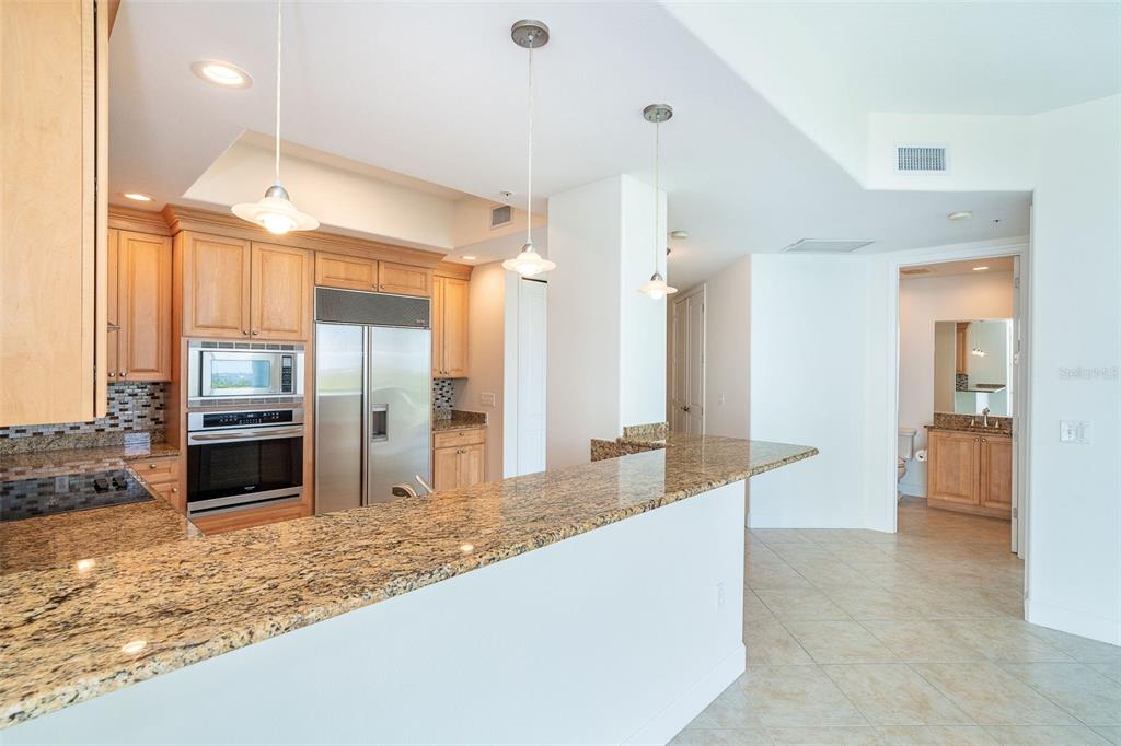 1375 Beach Road, Unit 210 Englewood, FL 34223 - Photo 19 of 49 a large kitchen with kitchen island granite countertop a refrigerator and a sink