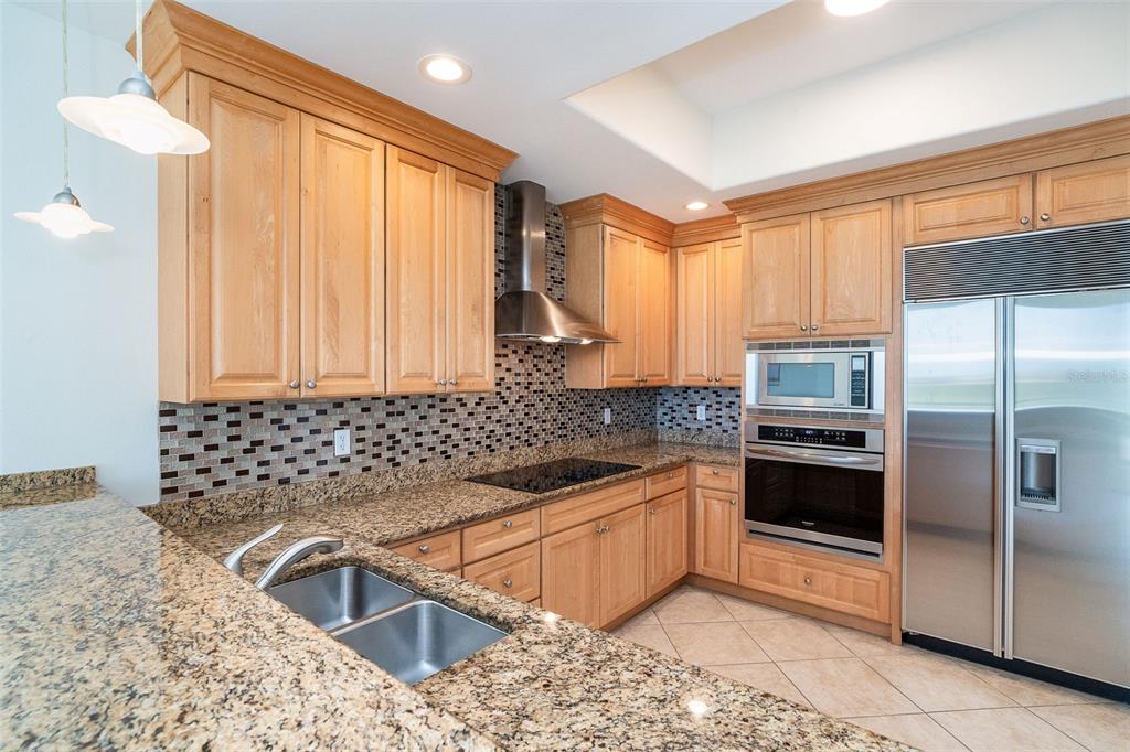 1375 Beach Road, Unit 210 Englewood, FL 34223 - Photo 20 of 49 a kitchen with granite countertop a sink stove and refrigerator