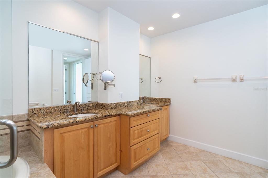1375 Beach Road, Unit 210 Englewood, FL 34223 - Photo 31 of 49 a bathroom with a granite countertop sink and a mirror