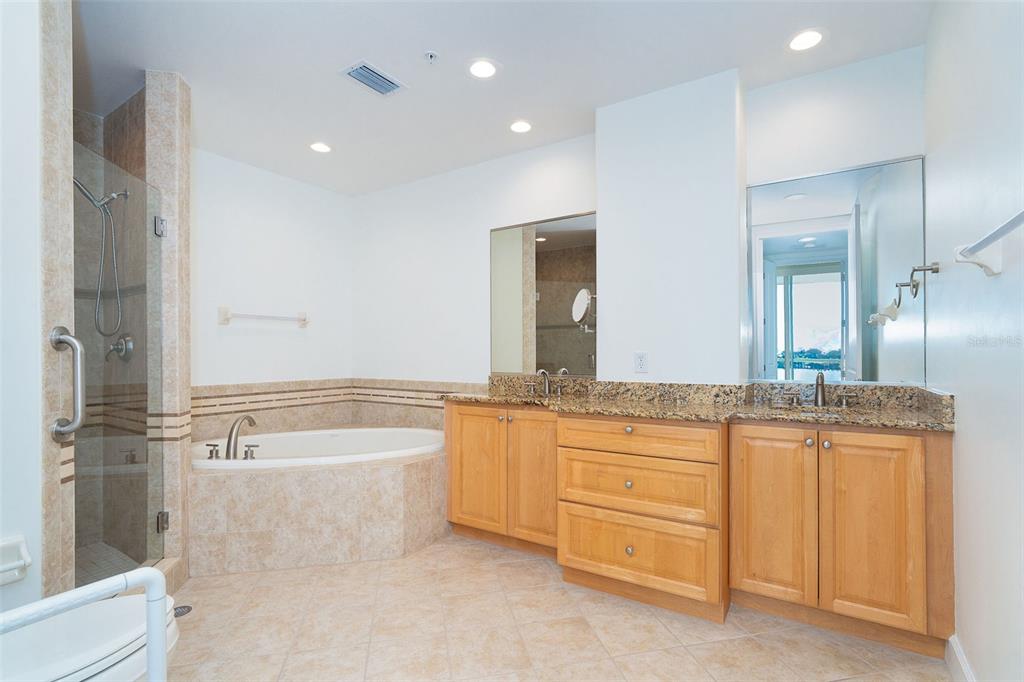 1375 Beach Road, Unit 210 Englewood, FL 34223 - Photo 32 of 49 a bathroom with a granite countertop sink a bathtub and a shower