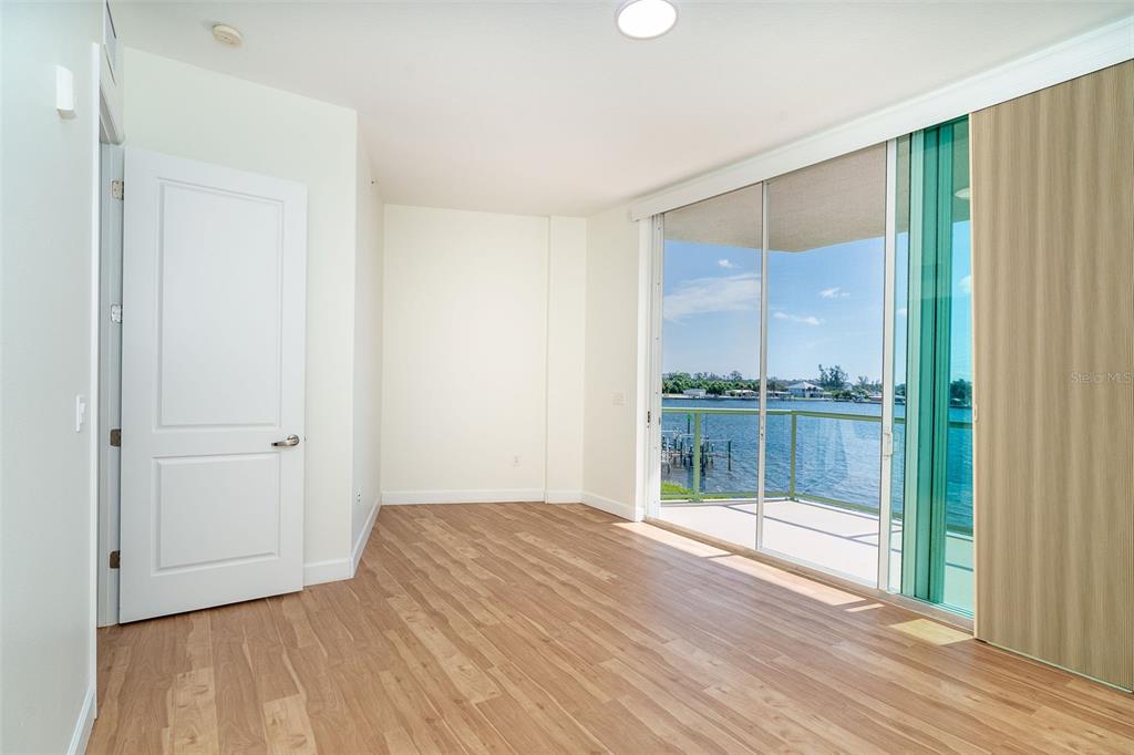 1375 Beach Road, Unit 210 Englewood, FL 34223 - Photo 37 of 49 a view of room with window and wooden floor