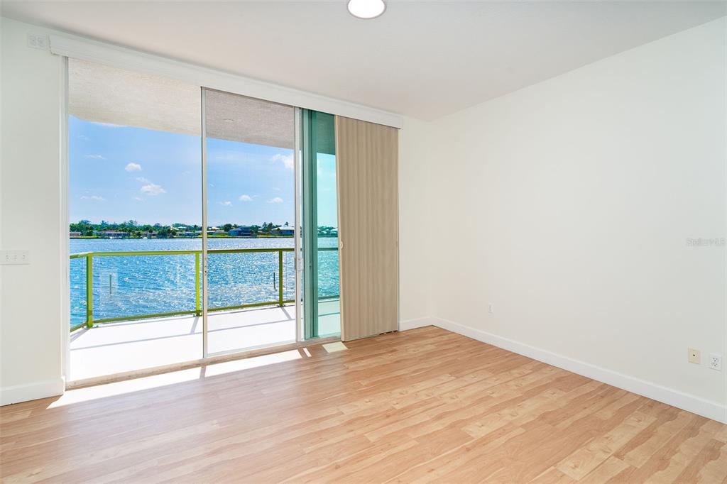 1375 Beach Road, Unit 210 Englewood, FL 34223 - Photo 38 of 49 an empty room with wooden floor and windows