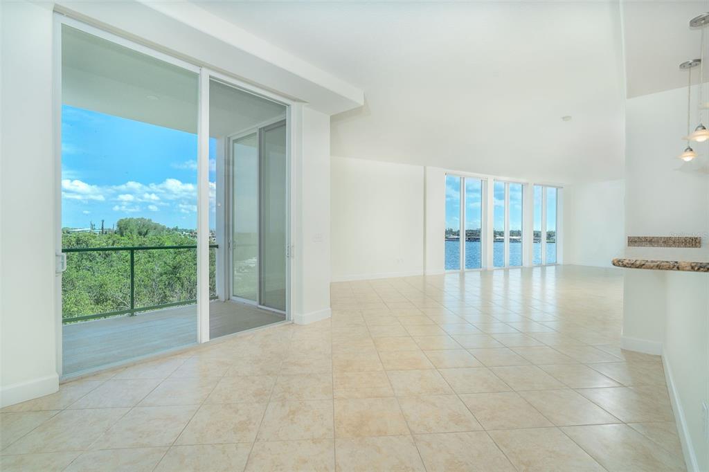 1375 Beach Road, Unit 210 Englewood, FL 34223 - Photo 8 of 49 a view of an empty room with floor to ceiling window and an outdoor view