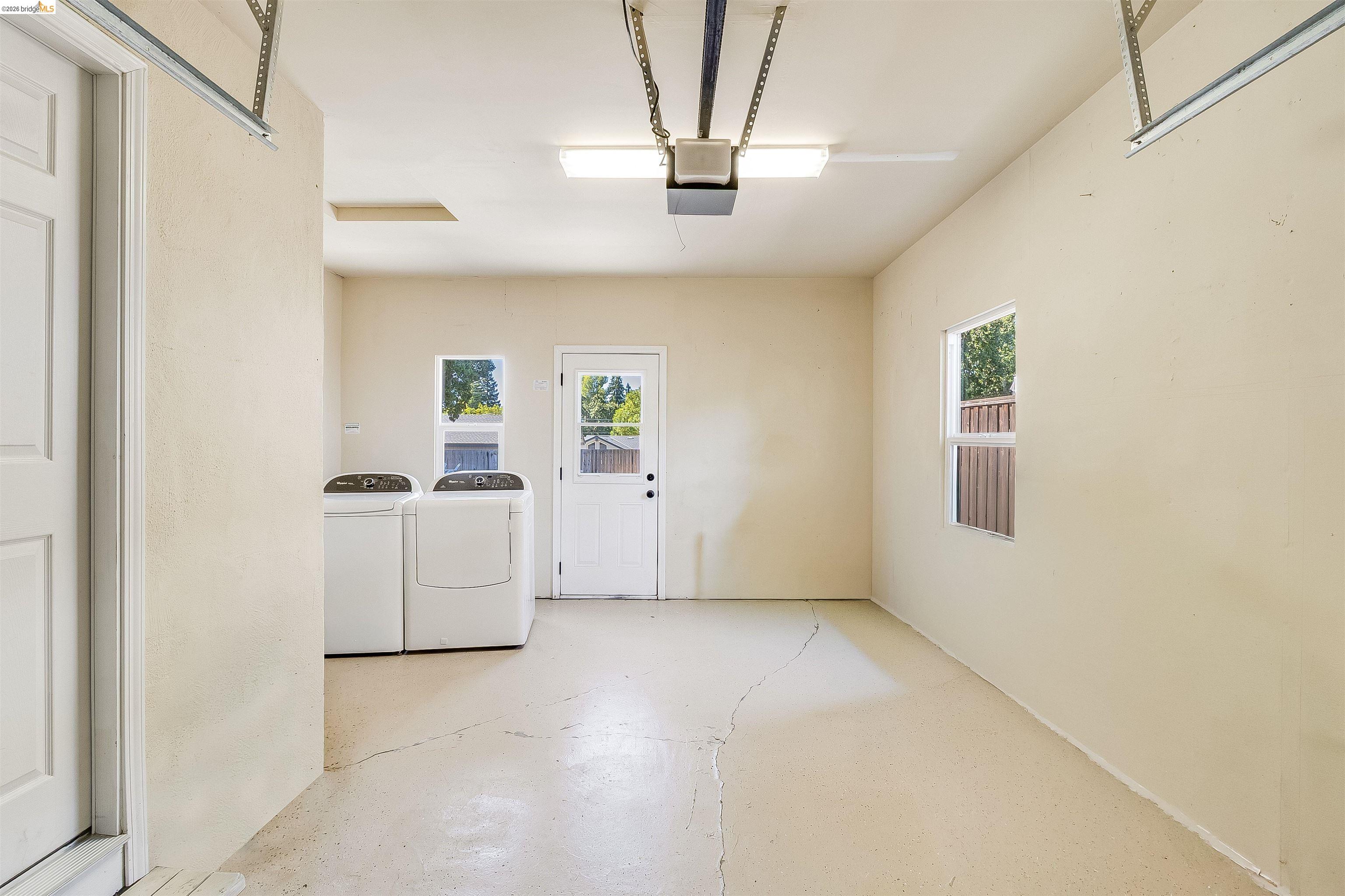 346 Valley View Road Pleasant Hill, CA 94523 - Photo 37 of 57 Spacious utility area featuring two windows, a side entry door, and overhead lighting