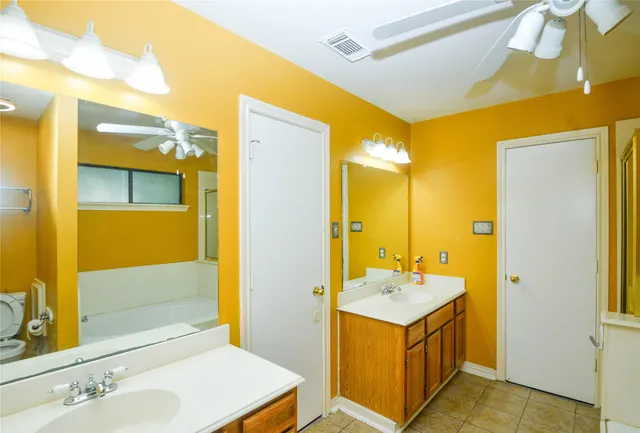 a bathroom with a sink mirror and a shower
