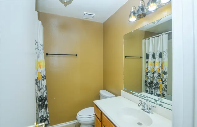 a bathroom with a sink mirror toilet and shower