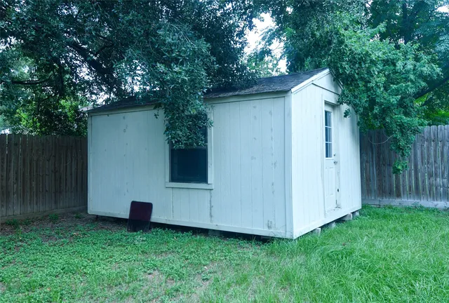a view of backyard with small cabin