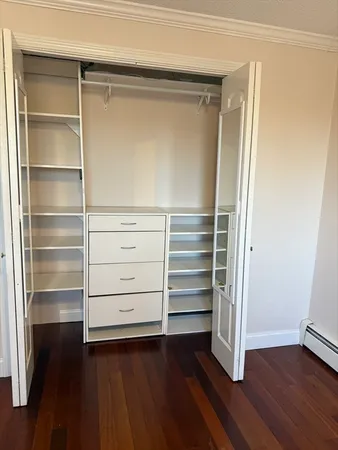 a view of walk in closet with empty racks