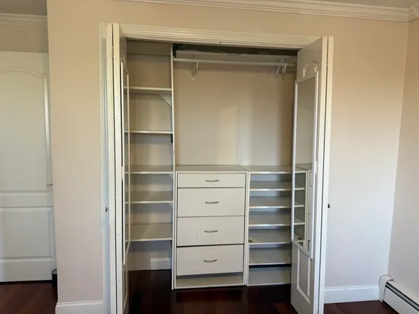 a view of walk in closet with empty racks