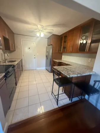 a view of a room with furniture and wooden floor