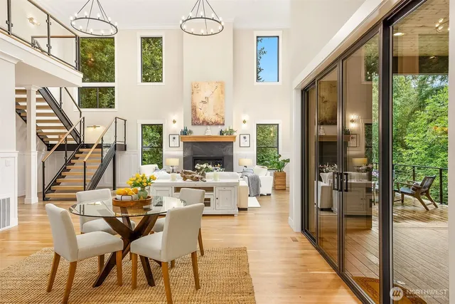 a living room with furniture a fireplace and a floor to ceiling window