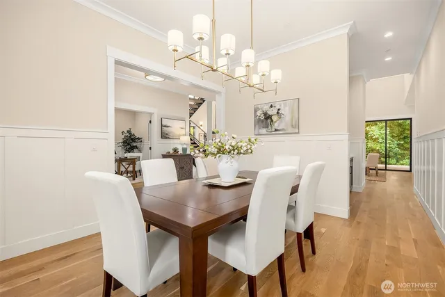 a view of a dining room with furniture and wooden floor