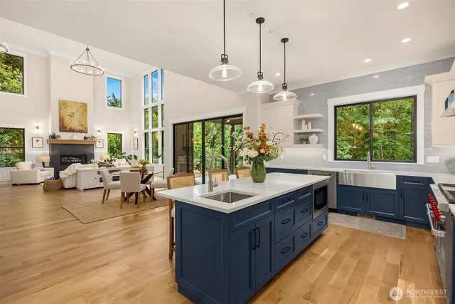 a kitchen with kitchen island granite countertop a stove and a living room view