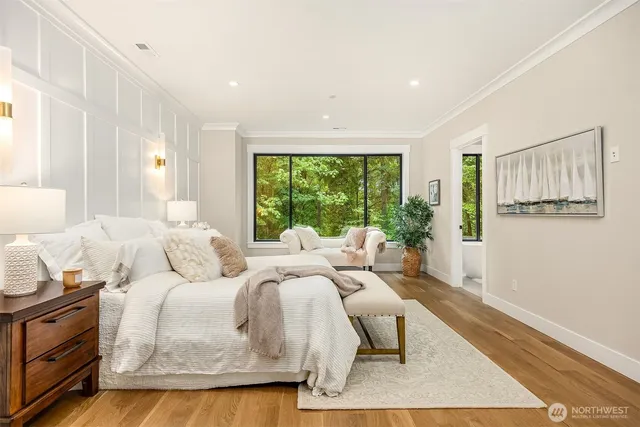 a bed room with two bed and a large window