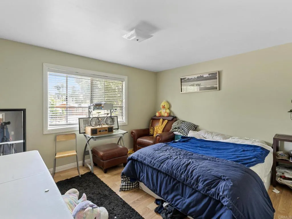1074 Balour Drive Encinitas, CA 92024 - Photo 13 of 37 a bedroom with bed and wooden floor