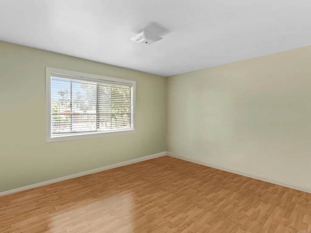 1074 Balour Drive Encinitas, CA 92024 - Photo 14 of 37 a view of an empty room with wooden floor and a window