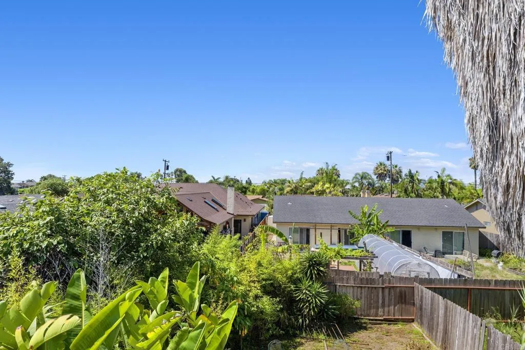 1074 Balour Drive Encinitas, CA 92024 - Photo 16 of 37 a front view of a house with a garden and a yard