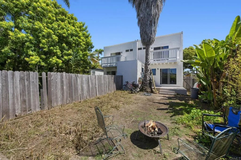 1074 Balour Drive Encinitas, CA 92024 - Photo 20 of 37 a backyard of a house with table and chairs with wooden fence