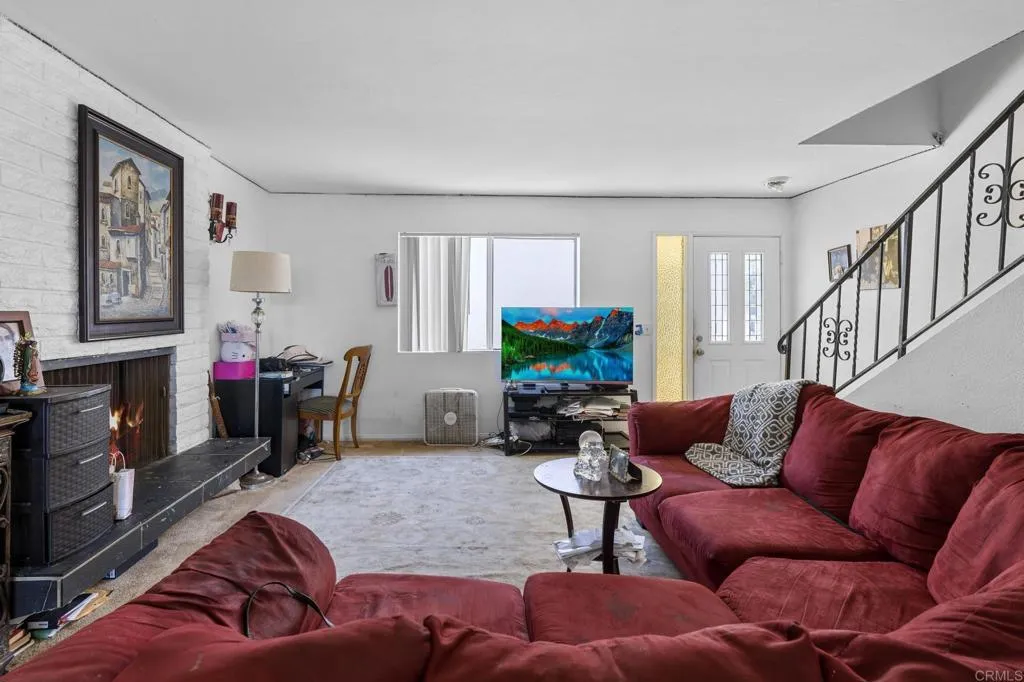 1074 Balour Drive Encinitas, CA 92024 - Photo 22 of 37 a living room with furniture a fireplace and a flat screen tv