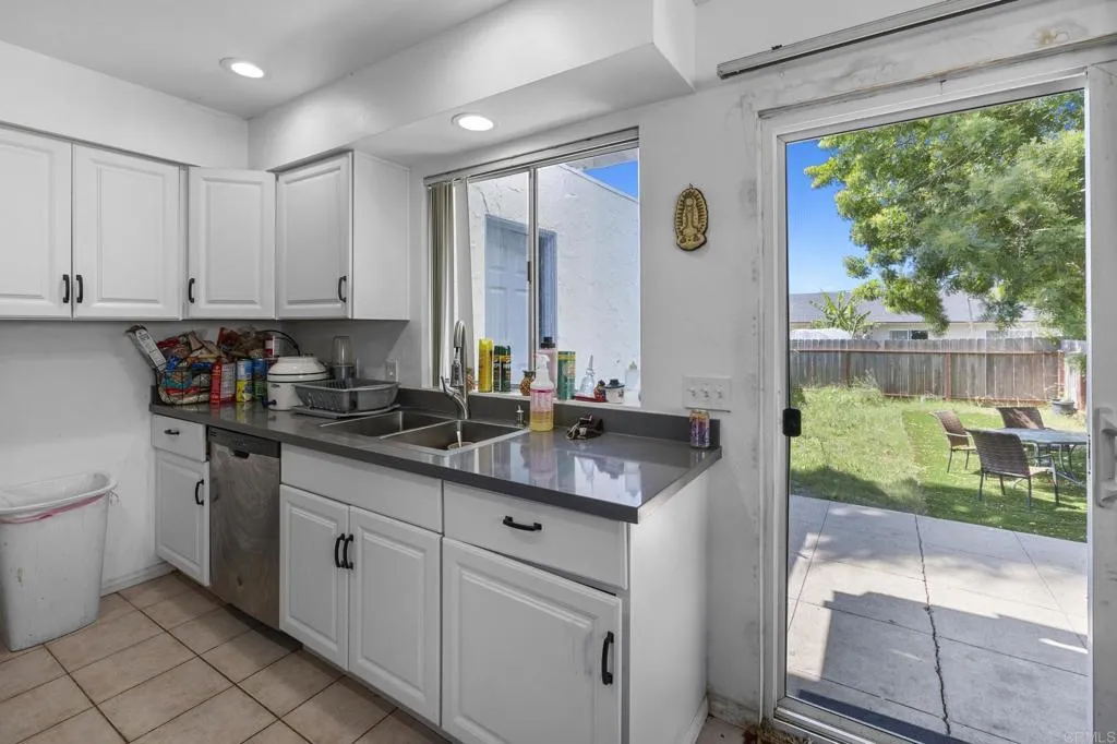 1074 Balour Drive Encinitas, CA 92024 - Photo 24 of 37 a kitchen with granite countertop a sink and white cabinets