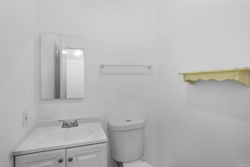 1074 Balour Drive Encinitas, CA 92024 - Photo 27 of 37 a bathroom with a sink and a mirror