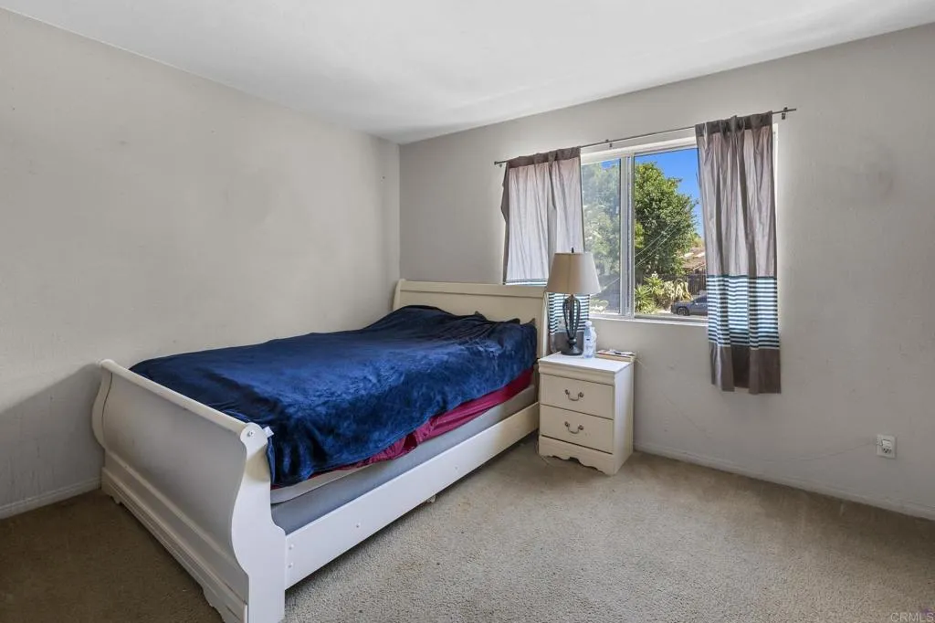 1074 Balour Drive Encinitas, CA 92024 - Photo 28 of 37 a spacious bedroom with a bed and window