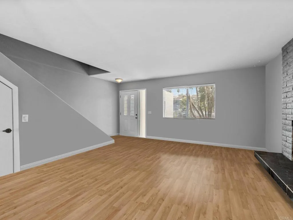 1074 Balour Drive Encinitas, CA 92024 - Photo 8 of 37 a view of an empty room with wooden floor and a window