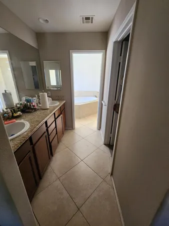 a bathroom with a sink a toilet and mirror