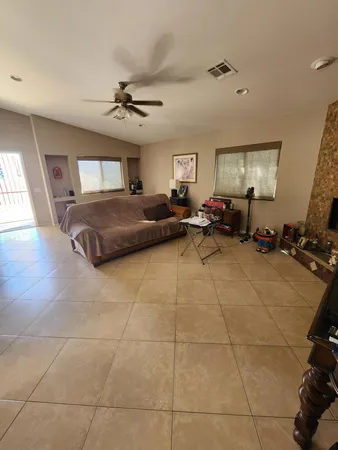 a living room with a couch and a gym machine