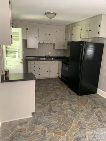 a kitchen with cabinets and a stove