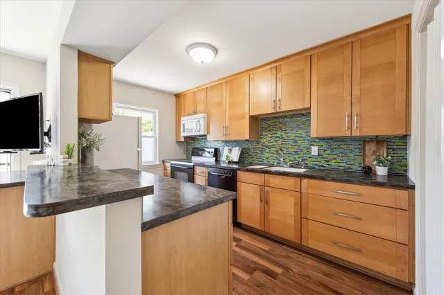 a kitchen with stainless steel appliances kitchen island granite countertop a sink and cabinets