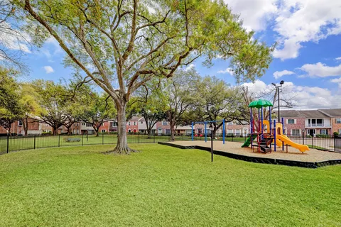 a view of a park with swings and slides