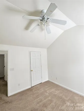 an empty room with fan and entryway