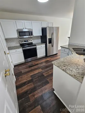 a kitchen with kitchen island wooden cabinets and stainless steel appliances