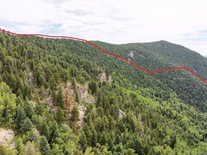 a view of a mountain range with lush green forest