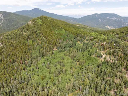 a view of a mountain range in a cloudy sky