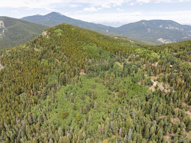 a view of a mountain range in a cloudy sky