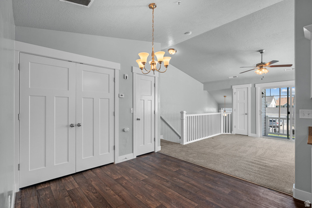 2457 West 500 South, Unit 2 Springville, UT 84663 - Photo 10 of 27 Open concept living space featuring wood-finish flooring, a contemporary chandelier, white paneled doors, and a ceiling fan