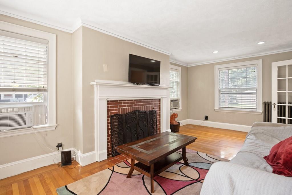 42 Spring Street Wakefield, MA 01880 - Photo 8 of 30 a living room with furniture fireplace and window