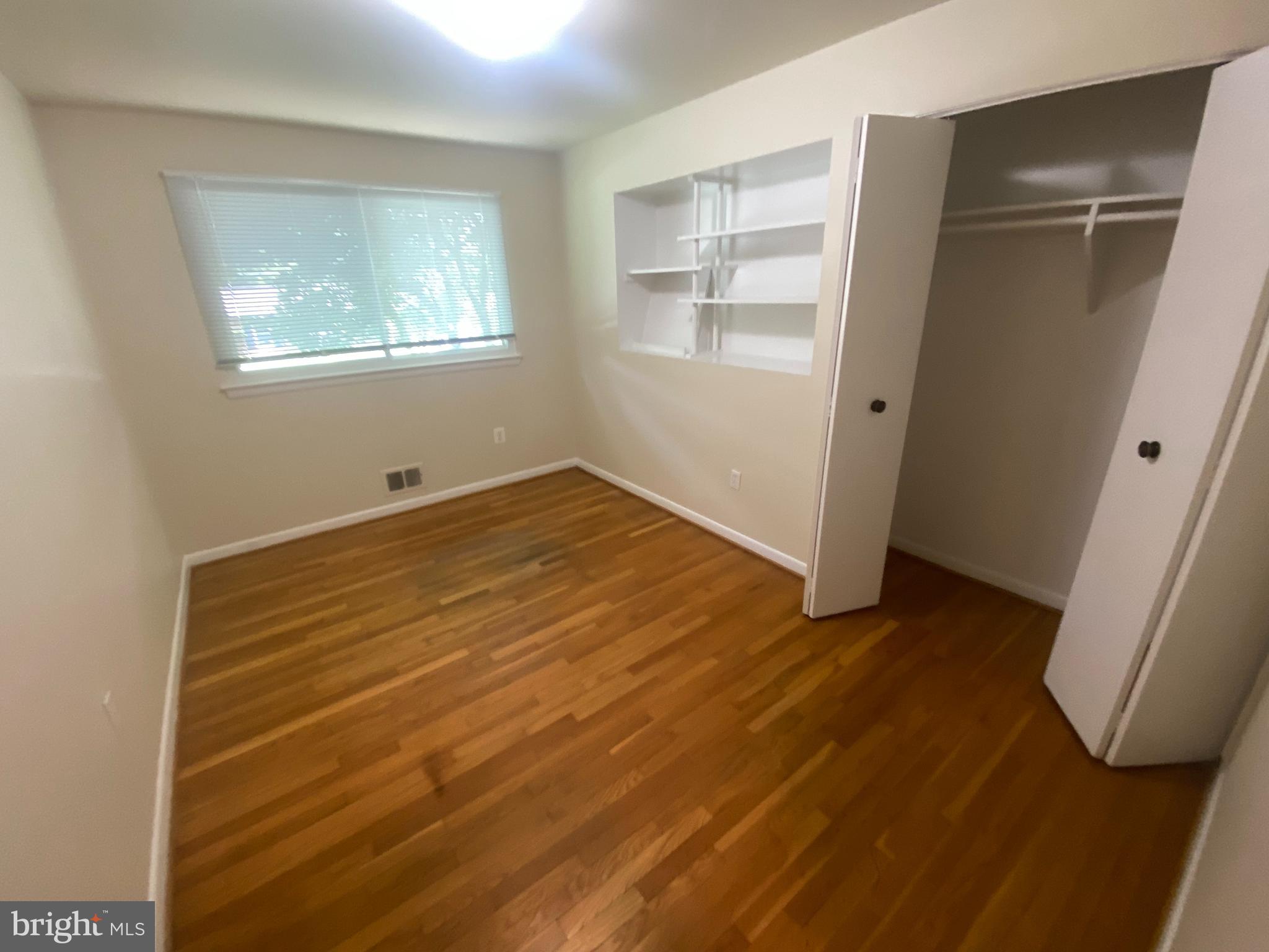 11602 Le Baron Terrace Silver Spring, MD 20902 - Photo 12 of 24 a view of an empty room with wooden floor and a window