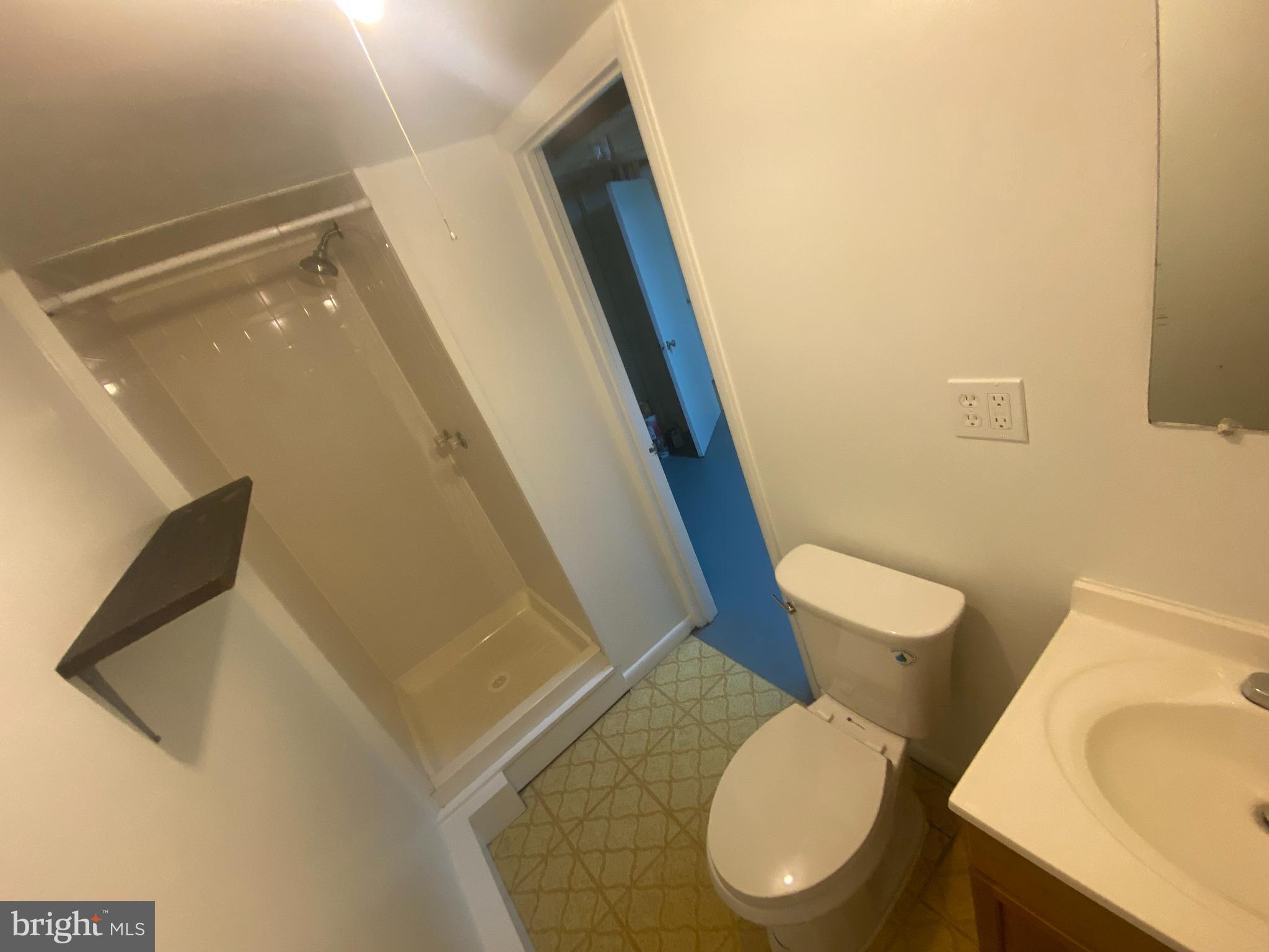 11602 Le Baron Terrace Silver Spring, MD 20902 - Photo 18 of 24 a white toilet sitting next to a bathroom sink and a mirror